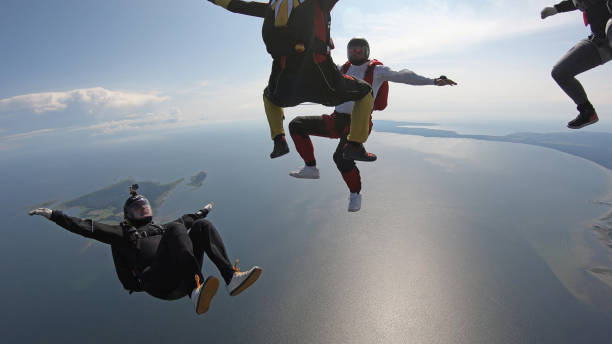 istock Skydivers fall through clear skies, in aerial flight 1176288803