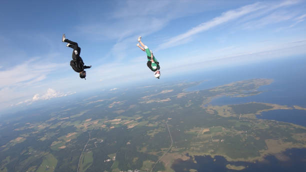 istock Skydivers fall through clear skies, in aerial flight 1176288806