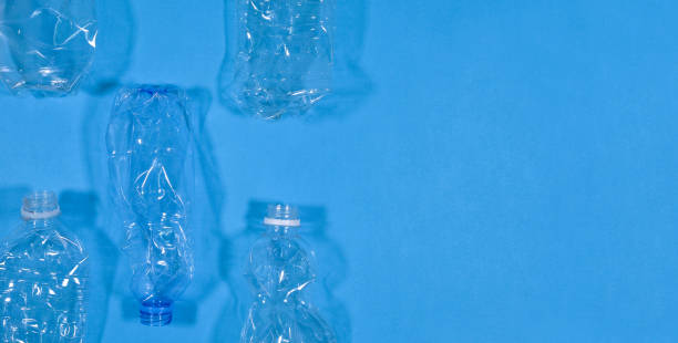 istock Plastic bottles isolated on blue background. Seamless pattern. Recycle waste management concept. Plastic Pet Bottles. Copy space 1176290500