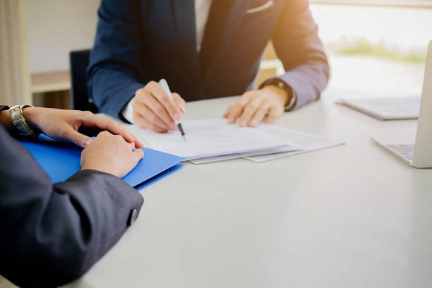 istock Interview  about to sign a legal document which would be a binding mutual agreement 1176291202