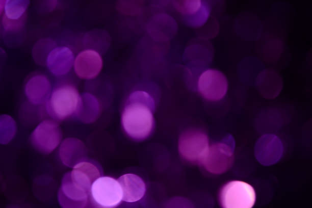 istock Bokeh. Holiday background. Christmas lights. Glitter. Defocused sparkles. New Year backdrop. Festive wallpaper. Blinks. Carnival. Tinsel. Bokeh retro style photo. Violet. Purple. 1176293739