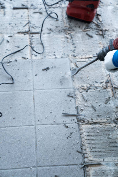 istock construction worker using a handheld demolition hammer and wall breaker to chip away and remove old floor tiles during renovation work 1176293921