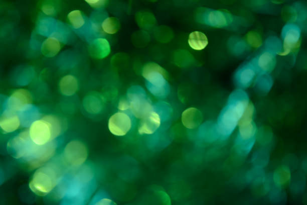 istock Bokeh. Holiday background. Christmas lights. Glitter. Defocused sparkles. New Year backdrop. Festive wallpaper. Blinks. Carnival. Tinsel. Bokeh retro style photo. Green. 1176293934