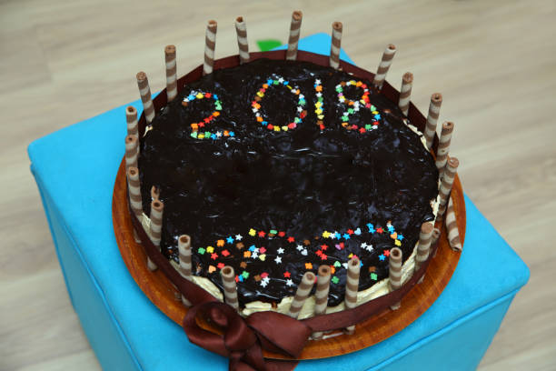 black chocolate cake. 2018 post on. Dark chocolate cake with whipped cream and chocolate sprinkles close up .