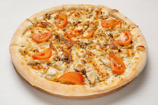 istock Italian pizza with chicken, walnuts and tomatoes, with white sauce 1176294962