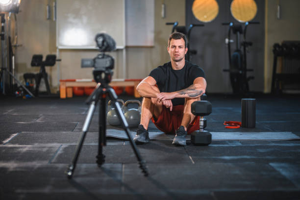 istock Fitness Trainer in Position to Film Weightlifting Tutorial 1176295988
