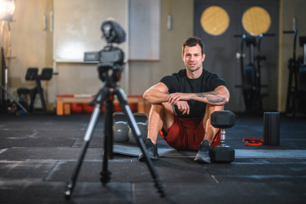 istock Fit Caucasian Male Athlete Creating Vlog About Weightlifting 1176295989