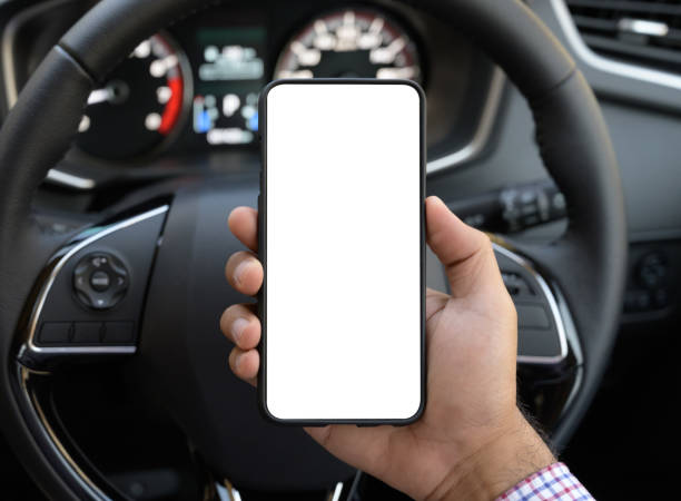istock Hand holding blank screen of smartphone while driving car. 1176296923