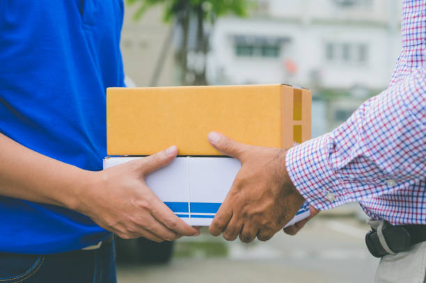 istock Hand accepting a delivery of boxes from deliveryman. 1176296994