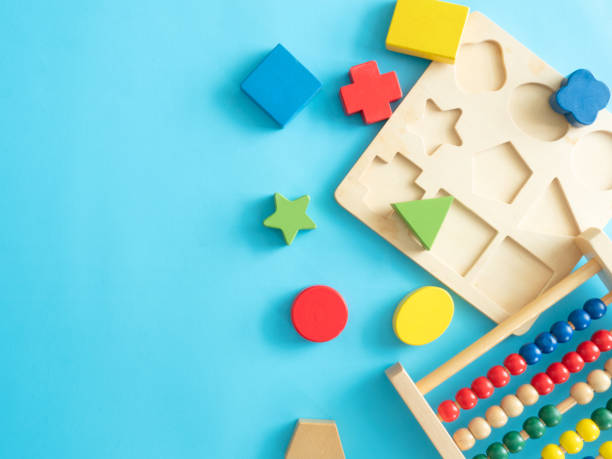 istock kids learning concept with stacking toys on blue table background. 1176297348