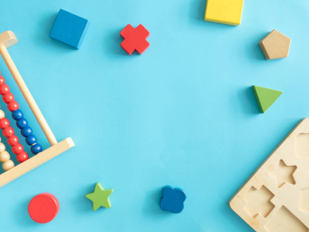 kids learning concept with stacking toys on blue table background. stock photo