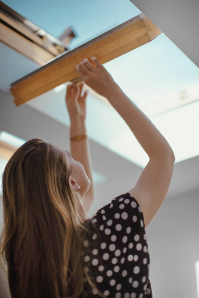 istock Young woman opening window. 1176298906