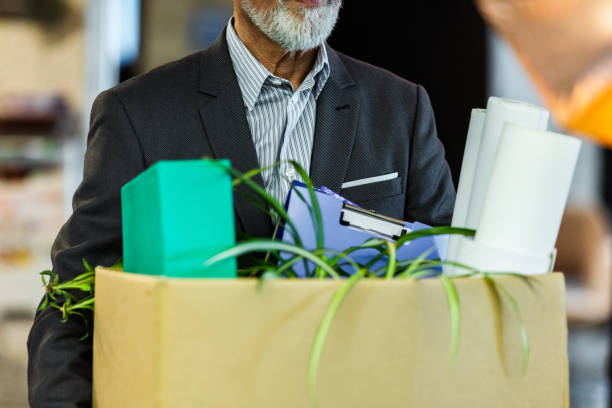 istock Unrecognizable businessman carrying his belongings after being fired. 1176299042