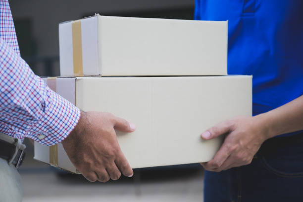 istock Hand accepting a delivery of boxes from deliveryman. 1176299175