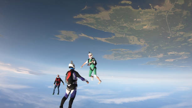 istock Skydivers fall through clear skies, in aerial flight 1176299854