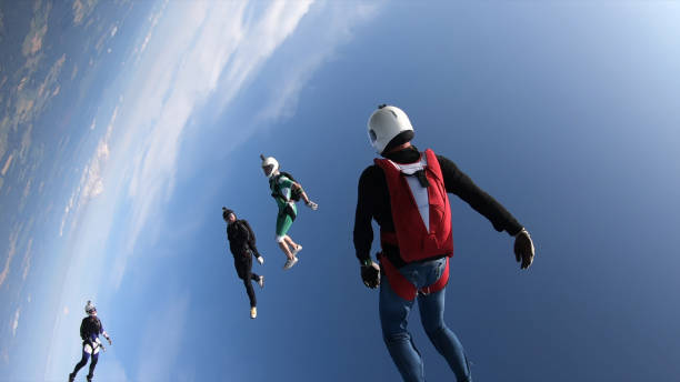 istock Skydivers fall through clear skies, in aerial flight 1176299857