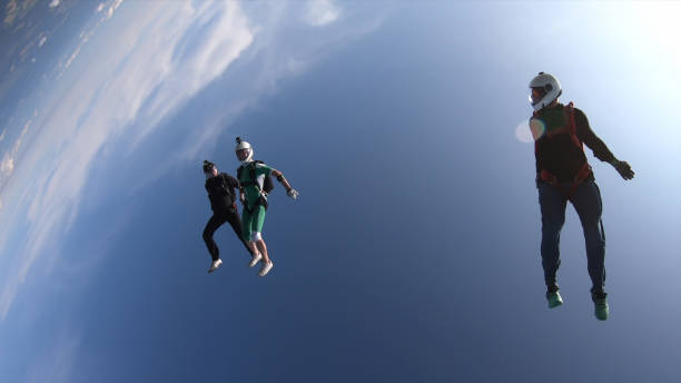 istock Skydivers fall through clear skies, in aerial flight 1176299870