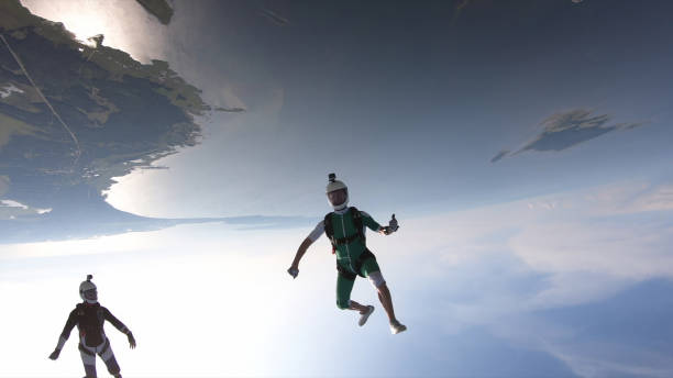 istock Skydivers fall through clear skies, in aerial flight 1176299875