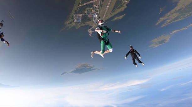 istock Skydivers fall through clear skies, in aerial flight 1176299931