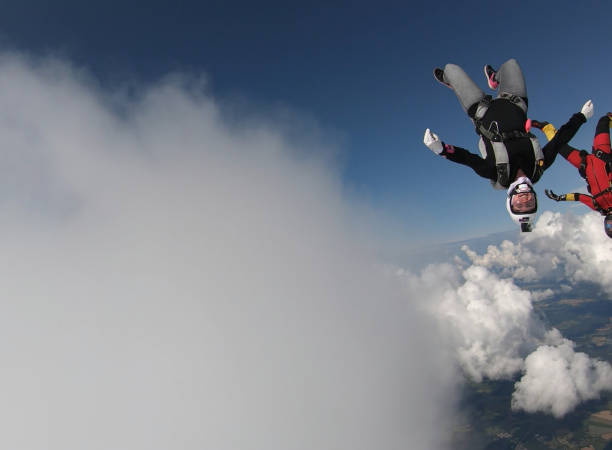 istock Skydivers fall through clear skies, in aerial flight 1176299960