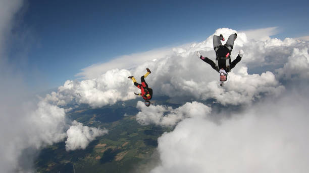 istock Skydivers fall through clear skies, in aerial flight 1176299968