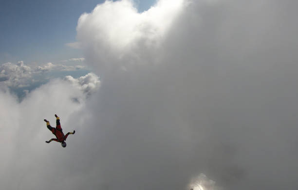 istock Skydiver falls through clear skies, in aerial flight 1176299992