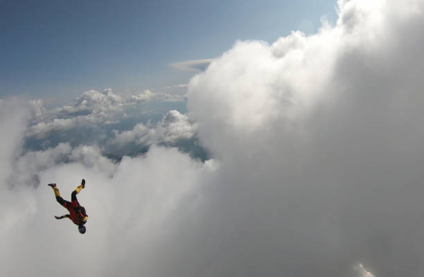 istock Skydiver falls through clear skies, in aerial flight 1176300007