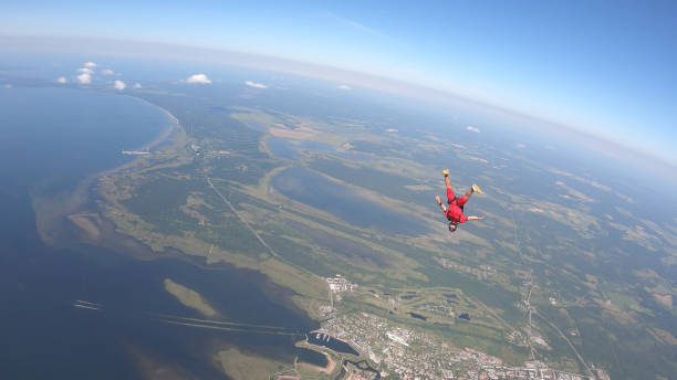 istock Skydiver falls through clear skies, in aerial flight 1176300027