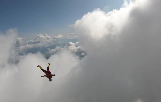 istock Skydiver falls through clear skies, in aerial flight 1176300029