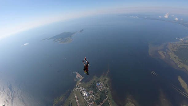 istock Skydiver falls through clear skies, in aerial flight 1176300035
