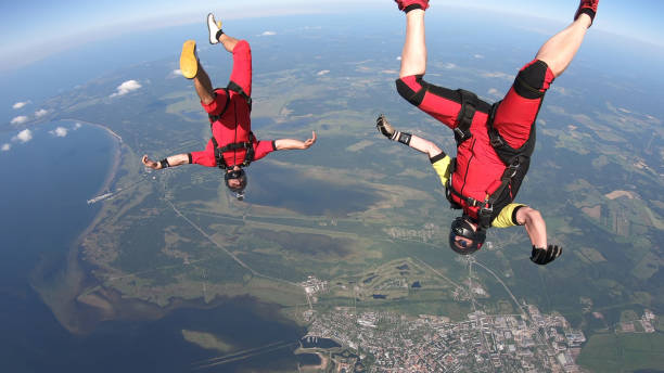 istock Skydivers fall through clear skies, in aerial flight 1176300050