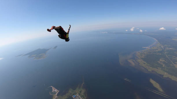 istock Skydiver falls through clear skies, in aerial flight 1176300058