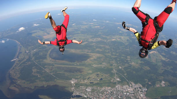 istock Skydivers fall through clear skies, in aerial flight 1176300060