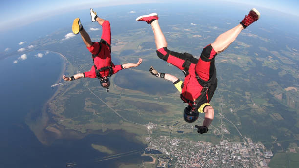 istock Skydivers fall through clear skies, in aerial flight 1176300077