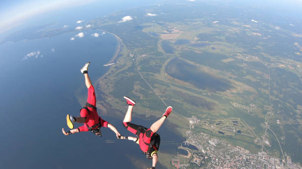istock Skydivers fall through clear skies, in aerial flight 1176300078