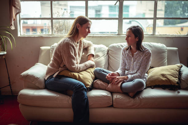 Mother and daughter talking Daughter is explaining to her mother what happened at school serious talk stock pictures, royalty-free photos & images