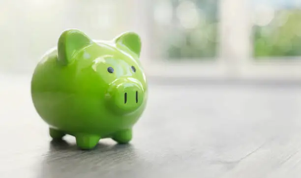 Photo of Piggy bank on home floor real estate investment concept