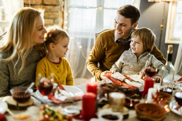 istock Happy parents enjoying with their kids at dining table. 1176302749