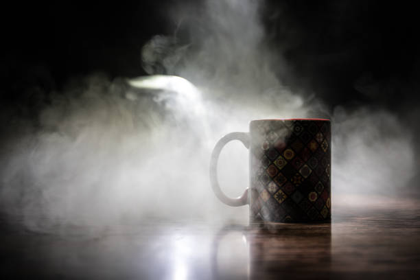 istock Beautiful eastern style textured ceramic cup of coffee (or tea) with smoke over dark toned background. 1176303171