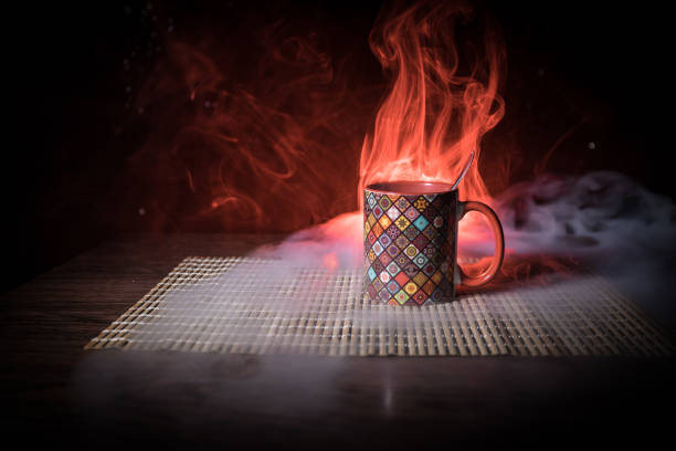 istock Beautiful eastern style textured ceramic cup of coffee (or tea) with smoke over dark toned background. 1176303684