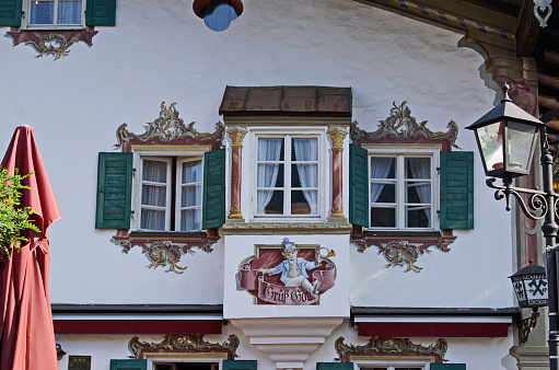 House with frescoes painting at the pedestrian zone of Oberammergau which is well known as home to a long tradition of woodcarving and for its famous Lüftlmalerei or frescoes.
