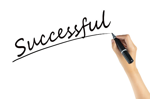 hand writing word successful with black color marker pen isolated on white background. business target to success concept