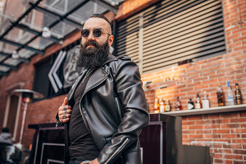 Handsome bearded man with leather jacket portrait.
