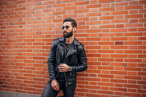 Handsome bearded man in black clothing portrait.