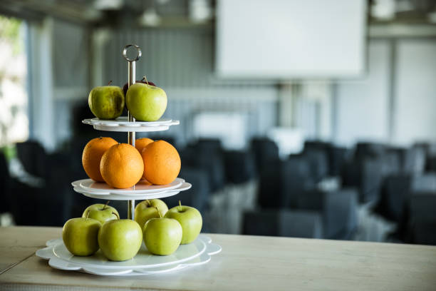Oranges and apples on a tray in a board room.