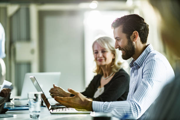 istock Happy businessman using laptop during a meeting in the office. 1176306989