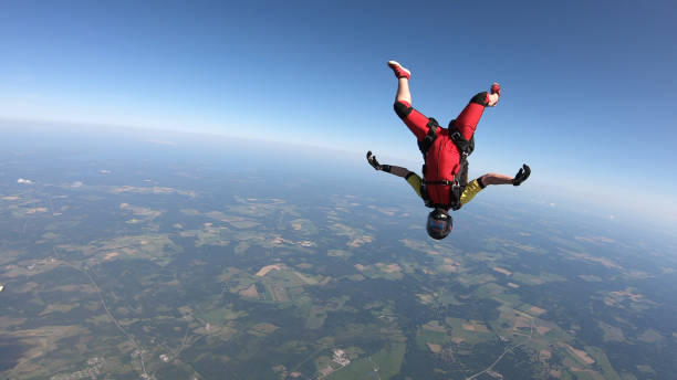 istock Skydiver falls through clear skies, in aerial flight 1176308651