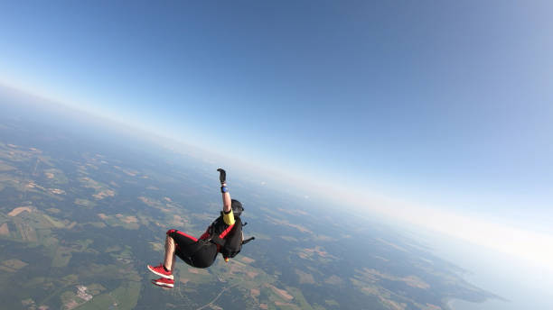 istock Skydiver falls through clear skies, in aerial flight 1176308664