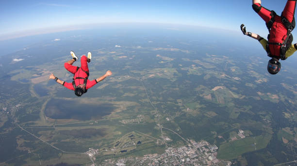 istock Skydivers fall through clear skies, in aerial flight 1176308681