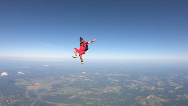 istock Skydiver falls through clear skies, in aerial flight 1176308689